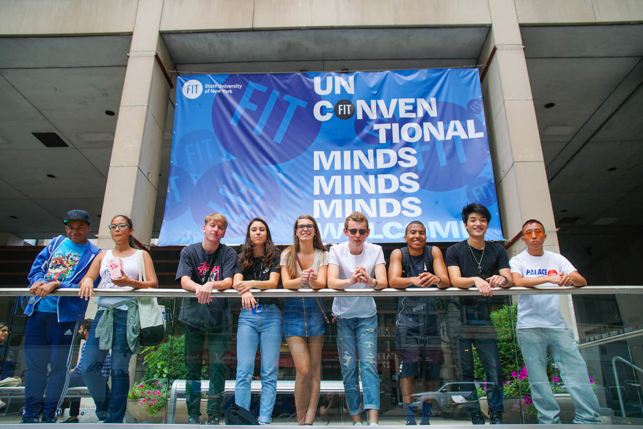 Students in front of a FIT banner.
