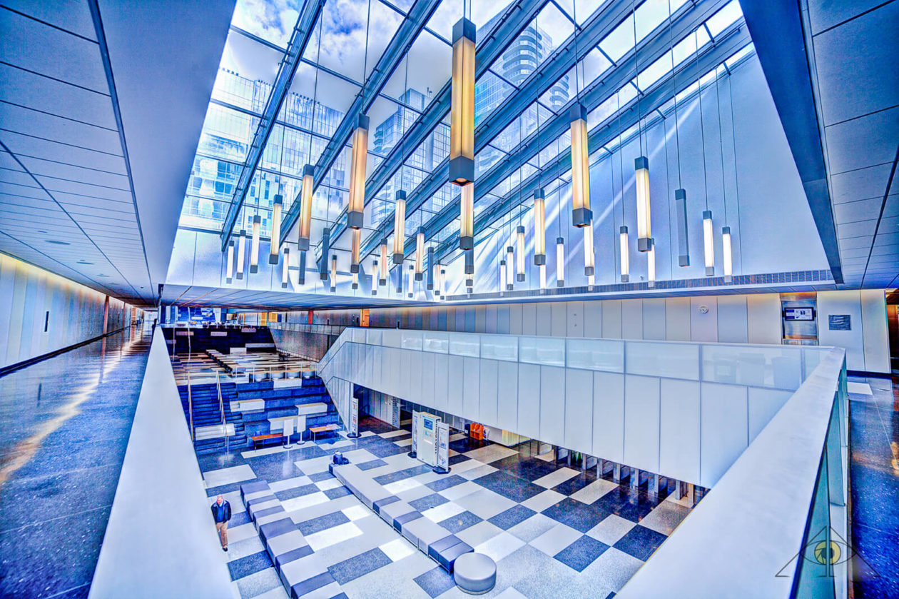 Interior view of college building with blue checked floor and skylights.