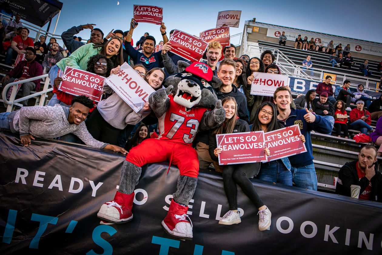 Students sitting in bleachers at a University of Stony Brook game.