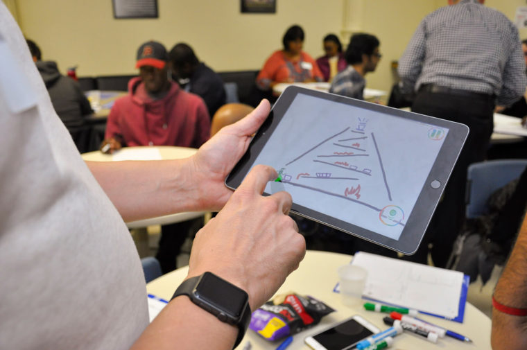Student drawing a sketch on a tablet.